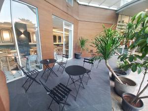 a patio with chairs and tables and plants in a building at Hotel 88 Kedoya Jakarta in Jakarta +43 photos