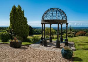 a gazebo in the middle of a garden at New House Country Hotel in Cardiff