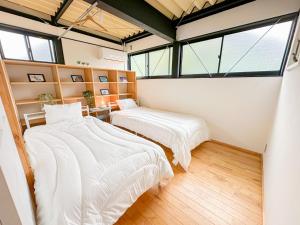 Postel nebo postele na pokoji v ubytování Eight Life Go-173ｍ2超の1棟貸し