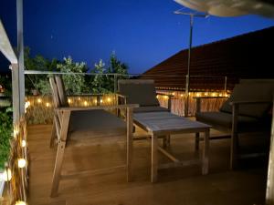 a deck with a bench and a table and lights at Casadeira de Mucha in Camariñas +13 photos