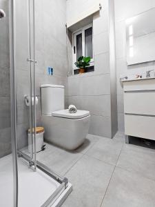 a white bathroom with a toilet and a shower at Bliss in Fgura +12 photos