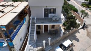 an aerial view of a white house with a balcony at Seaside Apartments in Emporeios