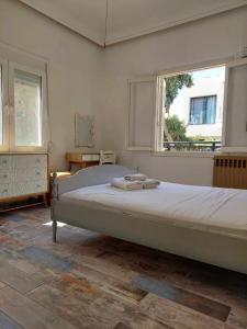 a bedroom with a large bed and a window at City Center First Floor Apartment in Kos