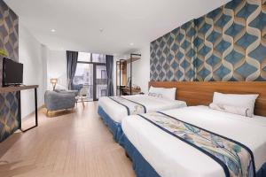 Postel nebo postele na pokoji v ubytování Essenza Hotel Đà Nẵng