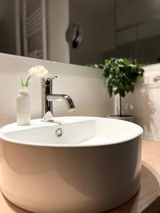 a white sink in a bathroom with a mirror at Scipioni Relais in Rome +17 photos