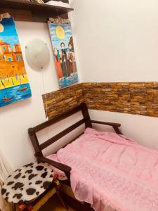 a bedroom with a pink bed and a painting at Sunny view South studio Мир Авангарда in Sunny Beach +19 photos