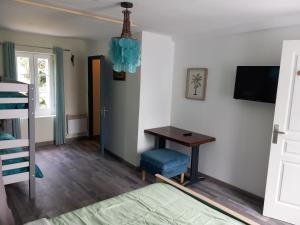a room with a desk and a bed and a television at Mont saint michel normandie in Sainte-Cécile