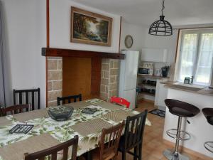 a kitchen and dining room with a table and chairs at Mont saint michel normandie in Sainte-Cécile