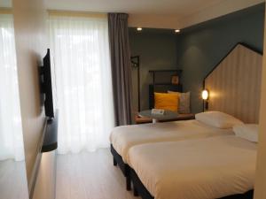 Postel nebo postele na pokoji v ubytování ibis Styles Arcachon Gujan Mestras