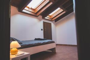 a bedroom with a bed with skylights in the ceiling at Castelletto - Armonia rustica e moderna in Bressana Bottarone