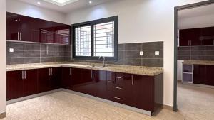 a large kitchen with a sink and a window at Mandela Suite, Ngor Almadies, Dakar, Senegal Appart 3 chambres, 3 salles de bain in Dakar