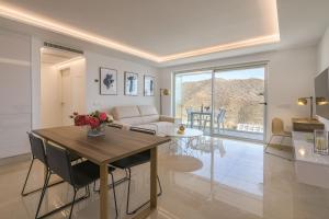 a living room with a table and a couch at Grand Horizon Luxury Boutique Apartments in Puerto Rico de Gran Canaria