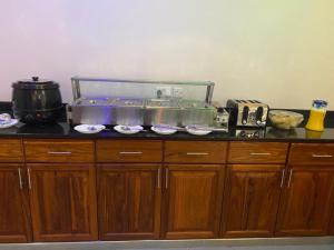 a kitchen counter with a fish tank on top of it at Medan Apartments in Arusha