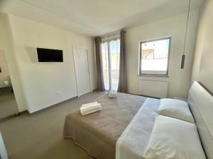 Postel nebo postele na pokoji v ubytování Arkè Rooms