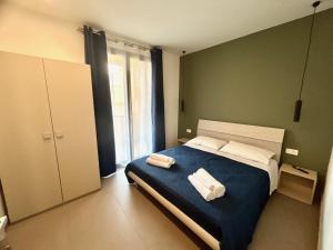 Postel nebo postele na pokoji v ubytování Arkè Rooms