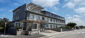 a building is being constructed on the side of a street at Le Relais des Iles in Coudeville