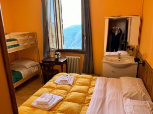a bedroom with a bed and a sink and a mirror at Baita Brunate Cao in Brunate