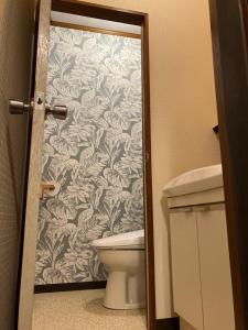 a bathroom with a toilet and a wallpaper at Otsu Nature Garden in Akiruno +154 photos