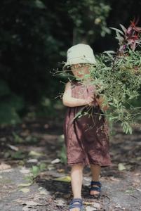 a child walking down a path with a plant at Dew&Plum 白露梅室 in Ruisui