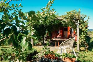 a white chair sitting in front of a house at Vineyard escape Šuklje in Metlika