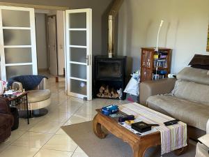 a living room with a couch and a fireplace at Maison Les Louves in Saint-Raphaël