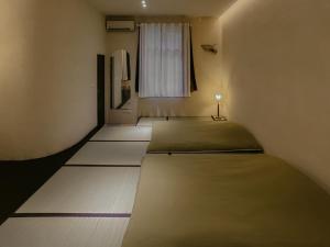 a room with two beds in it with a window at Dew&Plum 白露梅室 in Ruisui
