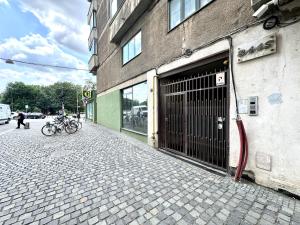 a bike parked in front of a building with a garage at Park View Studio in Timişoara