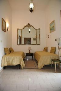 Ένα ή περισσότερα κρεβάτια σε δωμάτιο στο Bed and breakfast Casteltiziano Cicciano