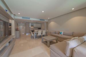 a living room with a couch and a table at Elegant apartment with pool and beach access in Hurghada +13 photos