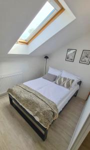 a bed in a room with a window at Apartament Quiet Street 11, 6E in Oświęcim