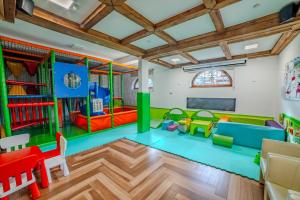 a childrens play room with a play area with play equipment at Pensjonat Sekuła*** in Bukowina Tatrzańska