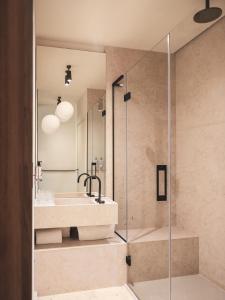 a bathroom with a sink and a shower at Hôtel Liautaud Rooftop Cassis in Cassis