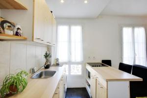 a kitchen with a sink and a counter top at Contemporary, view of La Défense, all comfort in Puteaux