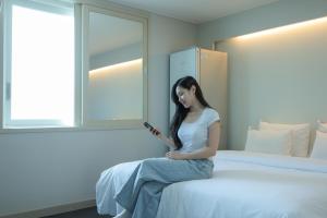Łóżko lub łóżka w pokoju w obiekcie VIP Hotel Mokpo