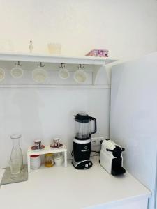 a kitchen with a coffee maker on a shelf at Daukanto Sea View Apartment, by luxuryrent in Palanga