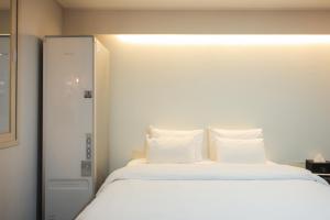 Łóżko lub łóżka w pokoju w obiekcie VIP Hotel Mokpo