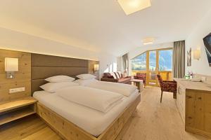 a bedroom with a large bed in a room at Hotel Kristall in Grossarl