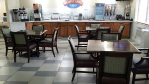 a dining room with tables and chairs in a restaurant at Park Inn by Radisson, Ames in Ames +2 photos