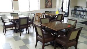 a dining room with wooden tables and chairs at Park Inn by Radisson, Ames in Ames
