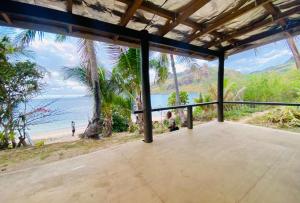 a view of the beach from the porch of a house at Maika Beachside homestay in Nalauwaki
