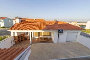 a view of a house with a roof with a patio at Vivenda Senhora das Areias in Aveiro