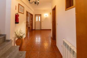 a hallway with a tile floor and a staircase at Vivenda Senhora das Areias in Aveiro