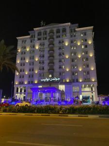 a large hotel with blue lighting in front of it at Golden Tulip Al Khobar in Al Khobar
