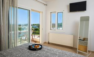 a room with a table with a bowl of food on it at Ormos Sea View Apartment in Agios Nikolaos +17 photos