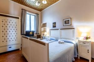 a bedroom with a large bed with two towels on it at Cascina Gaggioli in Milan