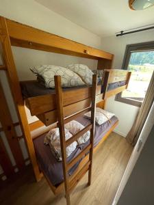 two bunk beds in a room with a window at Studio au pied des pistes in Bolquere Pyrenees 2000