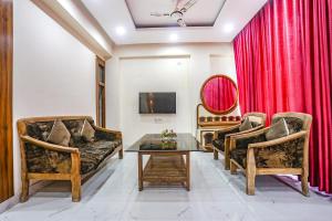 a living room with two couches and a table at FabHotel Imperail House in Prayagraj
