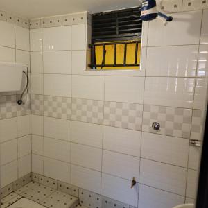 a bathroom with a shower with a window at Grassroots Cafe & Deli in Masaka +21 photos
