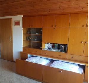 a kitchen with wooden cabinets and a counter top at Ferienwohnung Schmotzle in Überlingen