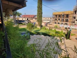 a garden with a pond in the middle of a city at Grassroots Cafe & Deli in Masaka